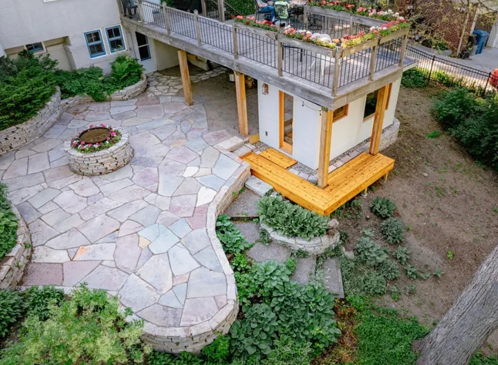 Drone view of a Chilton flagstone patio with a stone fire pit and dry-stacked walls